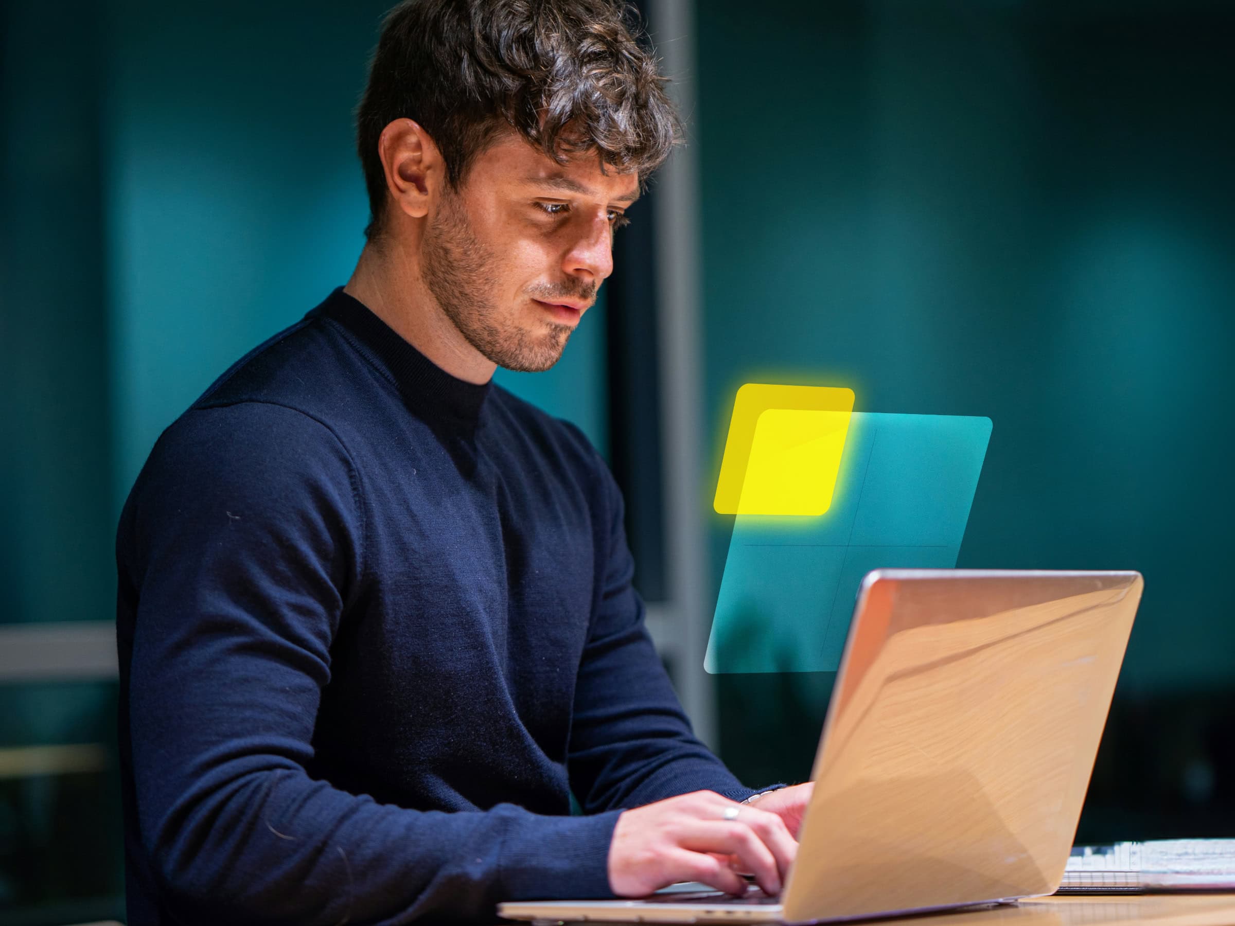 Man sitting at desk with laptop